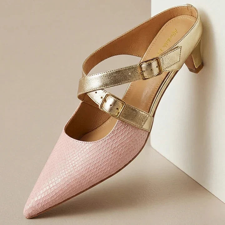 Pink textured leather mule with wraparound straps, gold buckles, and low heel.