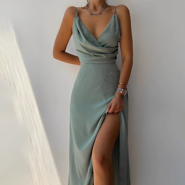 Teal satin slip dress with thin straps, cowl neckline, and thigh-high slit