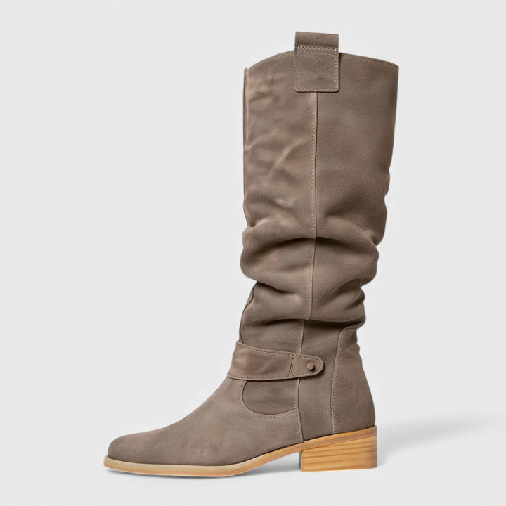 Light brown tall boots with side buckle strap and low block heel, pull-on fit