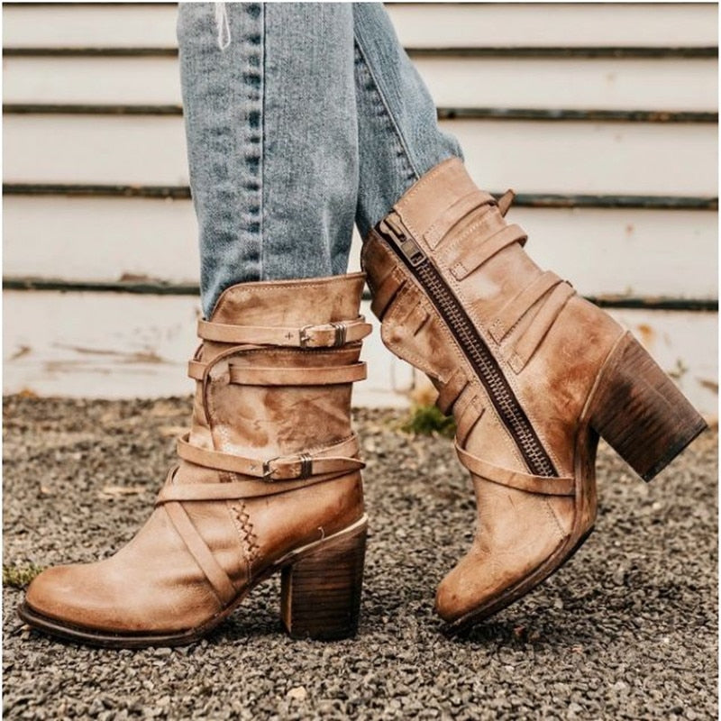 Brown slouchy leather ankle boots with buckle straps, side zipper, and block heel