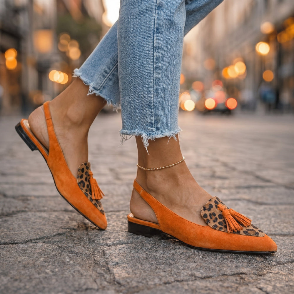 Orange suede tassel loafers with leopard-print insets and ankle chain detail