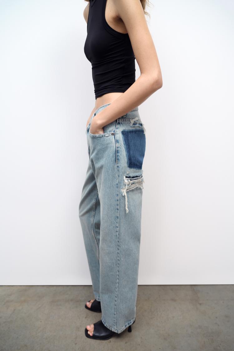 Light wash denim jeans, relaxed straight leg, side distress and frayed hem
