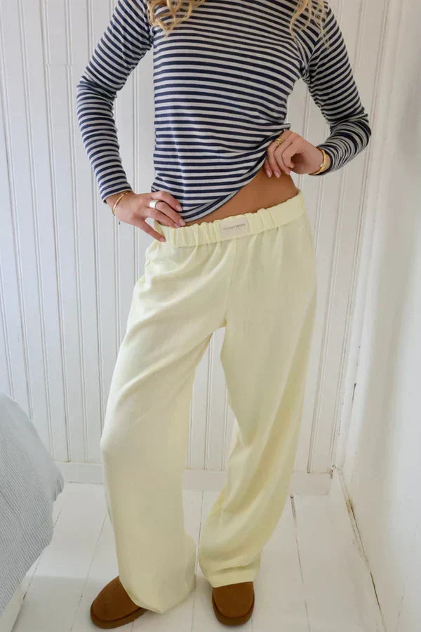 Cream lounge trousers with elastic waistband and relaxed wide straight legs, full view