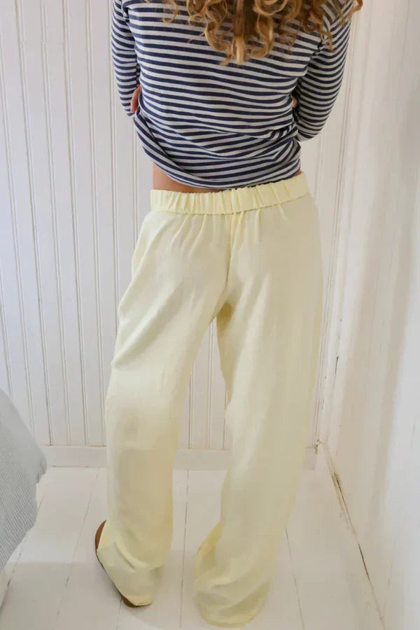 Cream lounge trousers with elastic waistband and relaxed wide straight legs