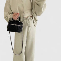 Zip-up sweater and drawstring pants set in light beige with adjustable waist and pockets.