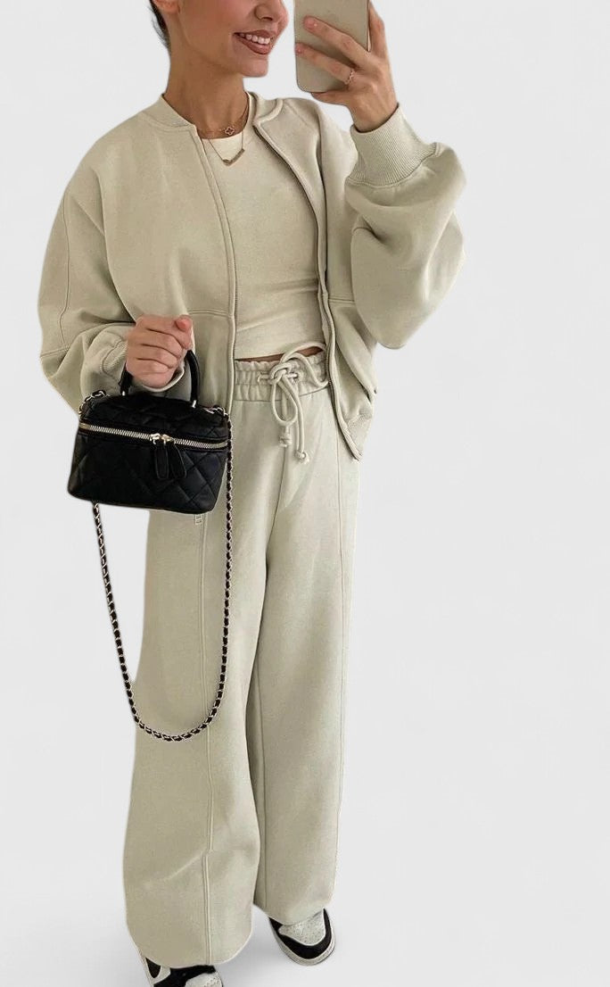 Zip-up sweater and drawstring pants set in light beige with adjustable waist and pockets.