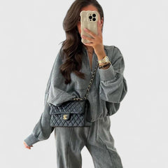 Zip-up sweater and drawstring pants set in charcoal gray, relaxed style with side pockets.