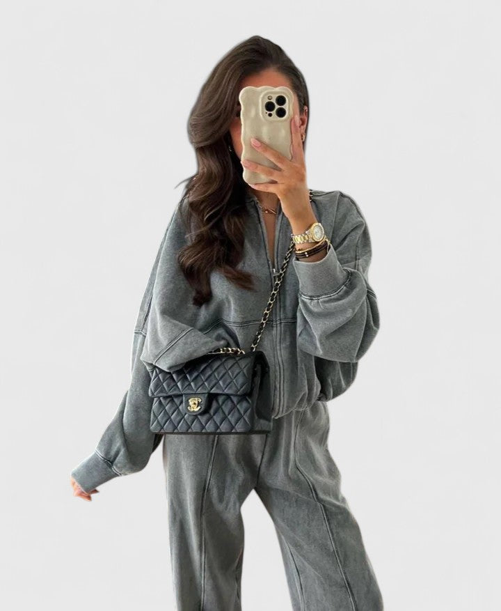 Zip-up sweater and drawstring pants set in charcoal gray, relaxed style with side pockets.