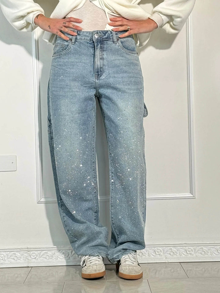 Light blue speckled denim trousers with wide legs, front zip fly and side pockets