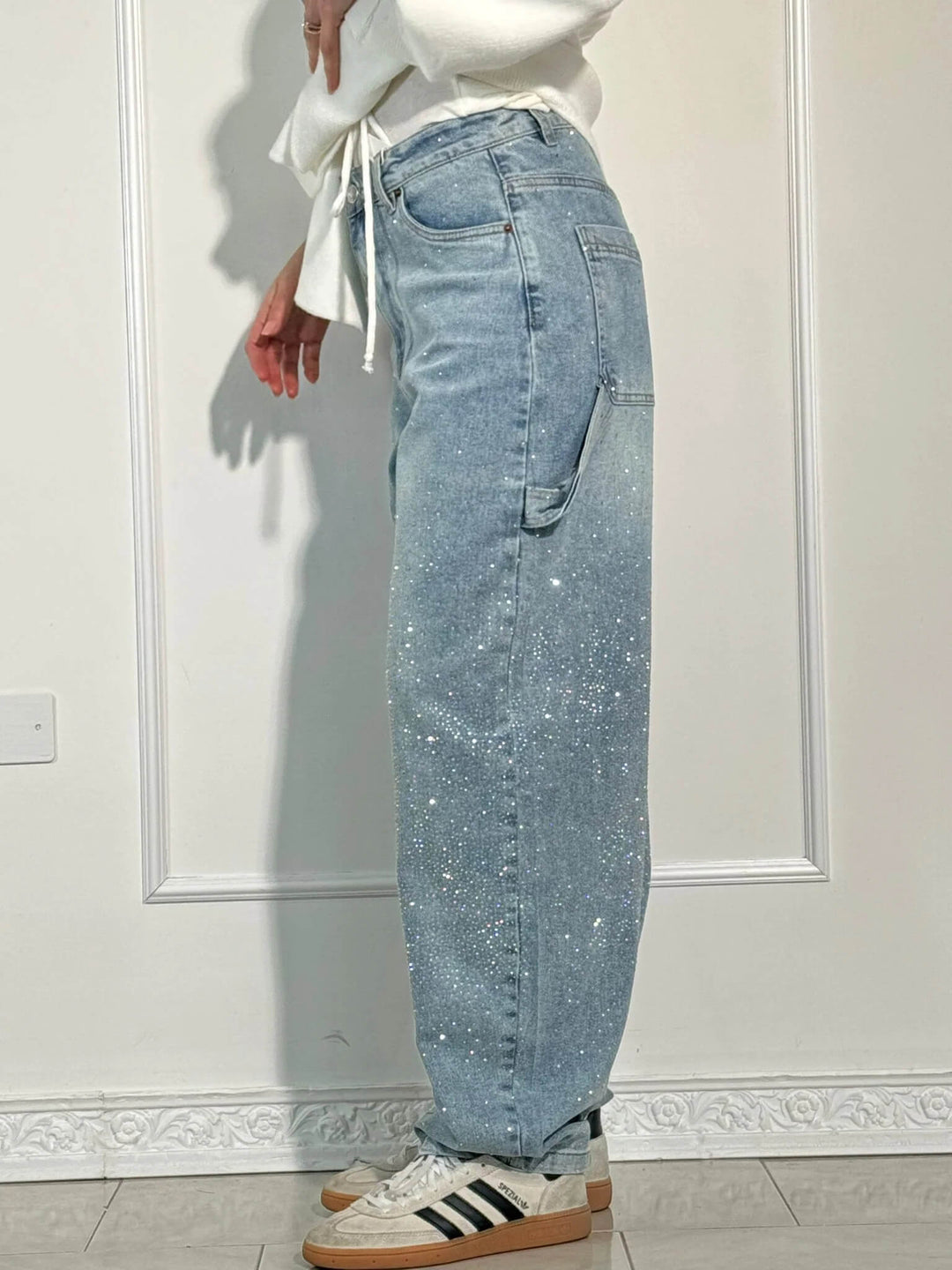 Light blue speckled denim trousers, relaxed wide-leg cut with belt loops and pockets