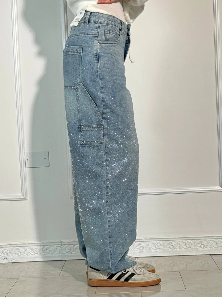 Light blue speckled wide-leg denim trousers with cargo-style side pocket and belt loops
