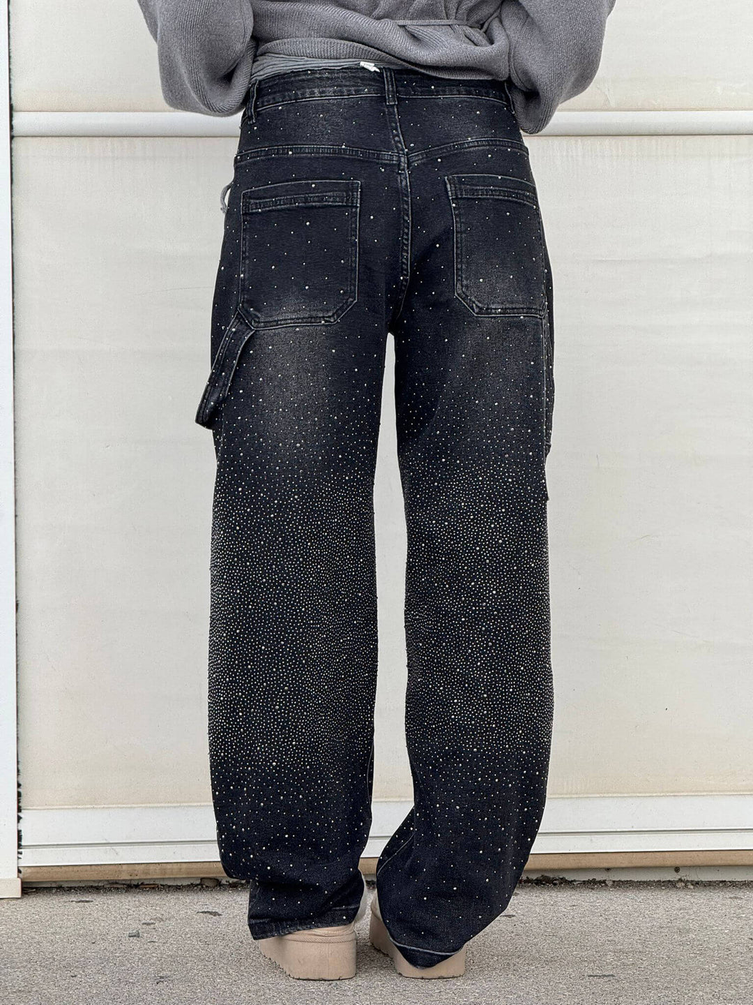 Black speckled denim trousers with wide legs, front button-zip fly and back pockets