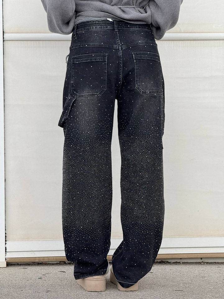 Black speckled denim trousers with wide legs, front button-zip fly and back pockets