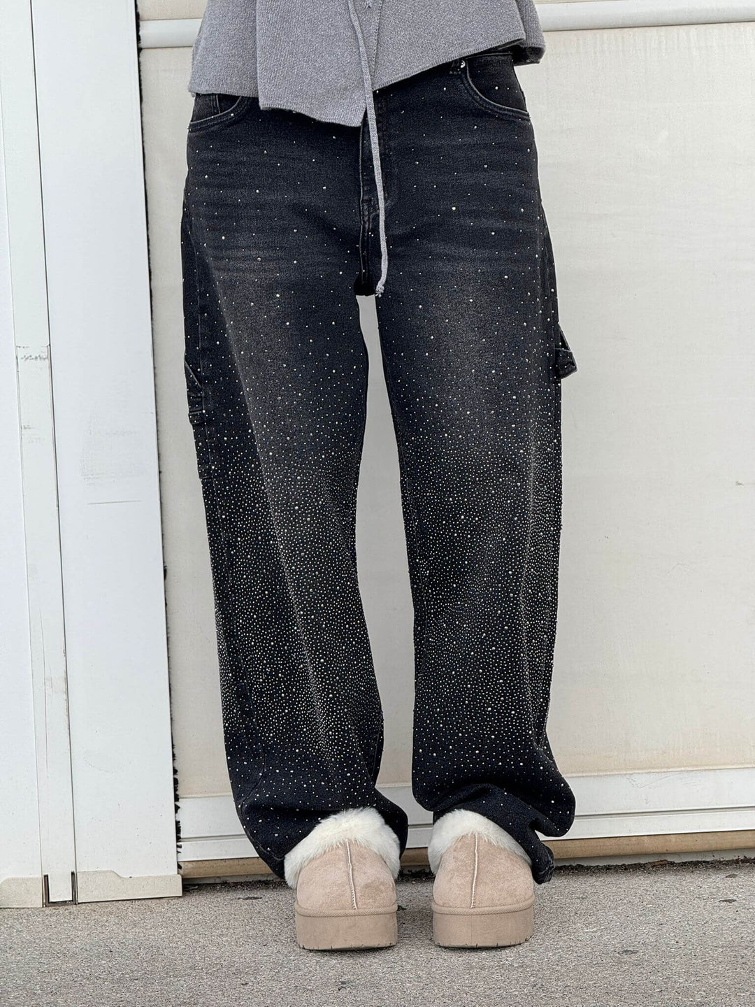 Black speckled denim trousers with wide-leg silhouette, zipper fly and belt loops