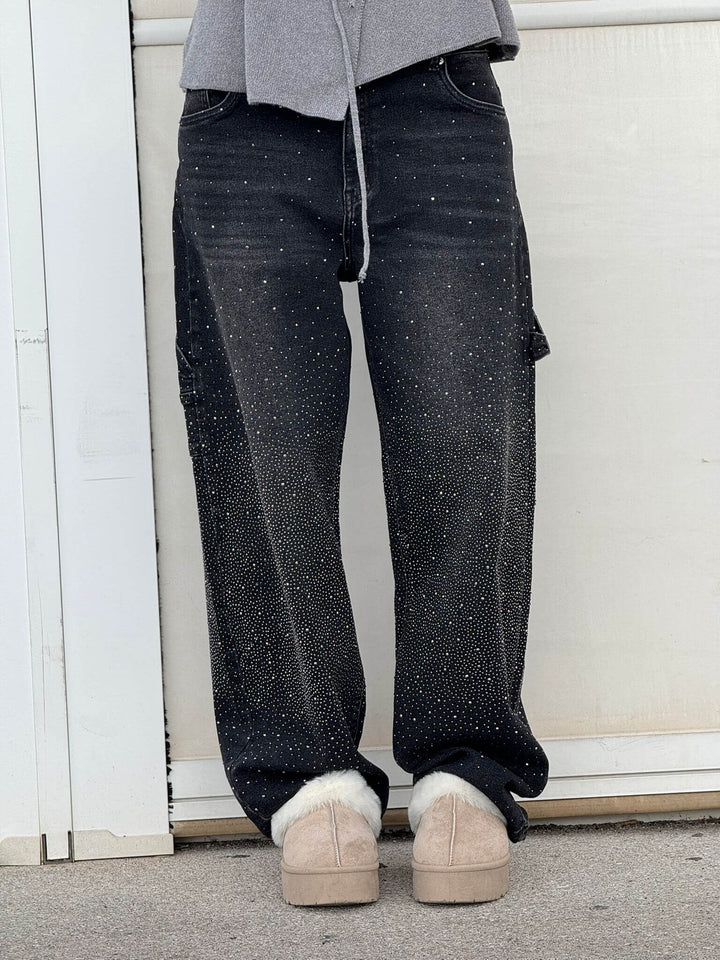 Black speckled denim trousers with wide-leg silhouette, zipper fly and belt loops