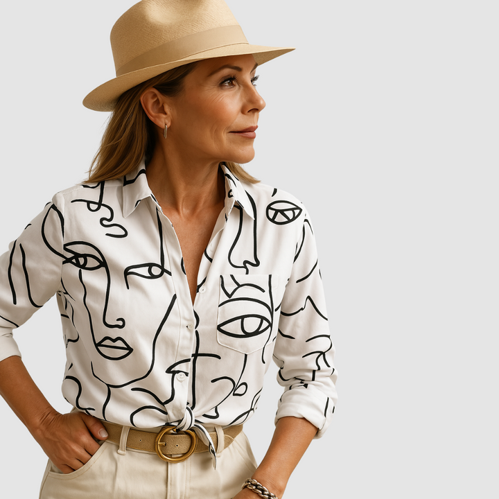 Soft white breathable blouse with black abstract line-art faces, button front