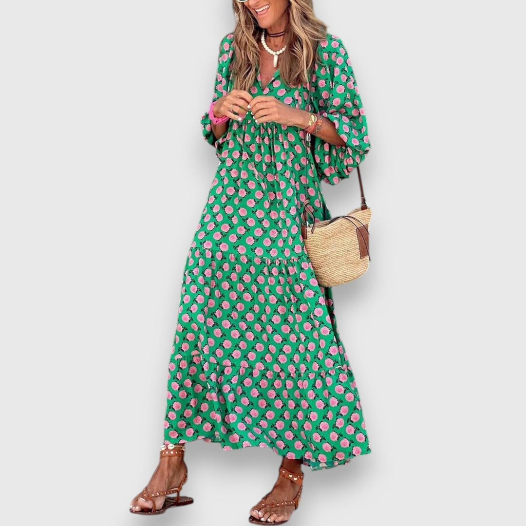 Loose breathable dress in green with pink floral print, V-neck, tiered skirt.