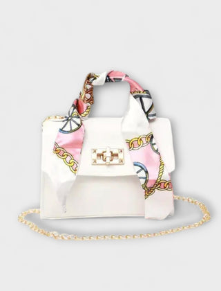 White handbag with gold clasp, chain strap, and light patterned scarf handles