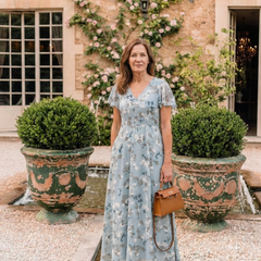 Sky blue floral chiffon maxi dress with V-neck and short sleeves, tiered skirt.