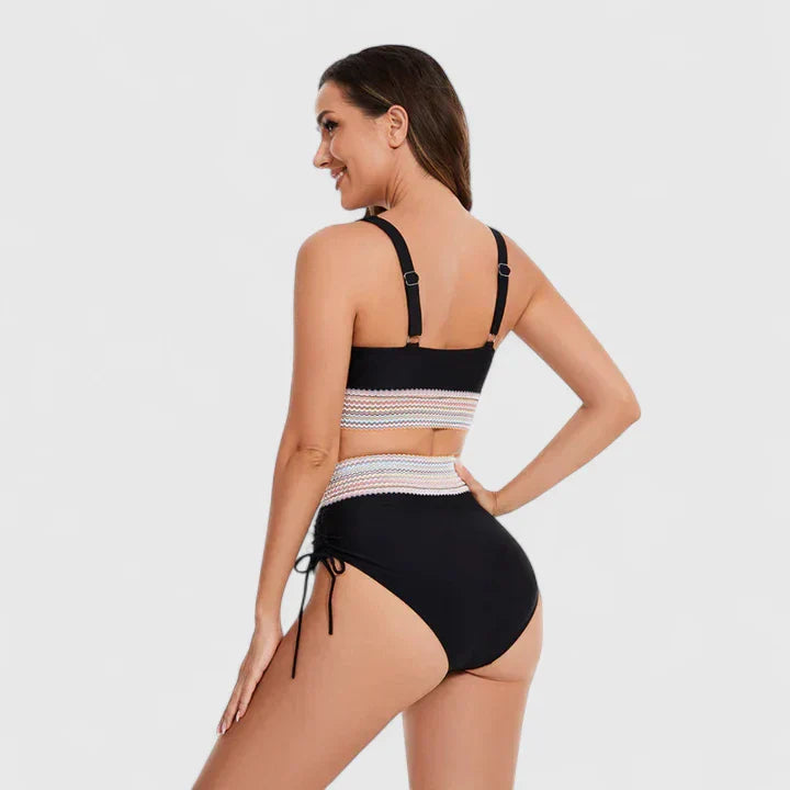 Black bikini set with striped tummy band, open-back straps, and tie-side bottoms