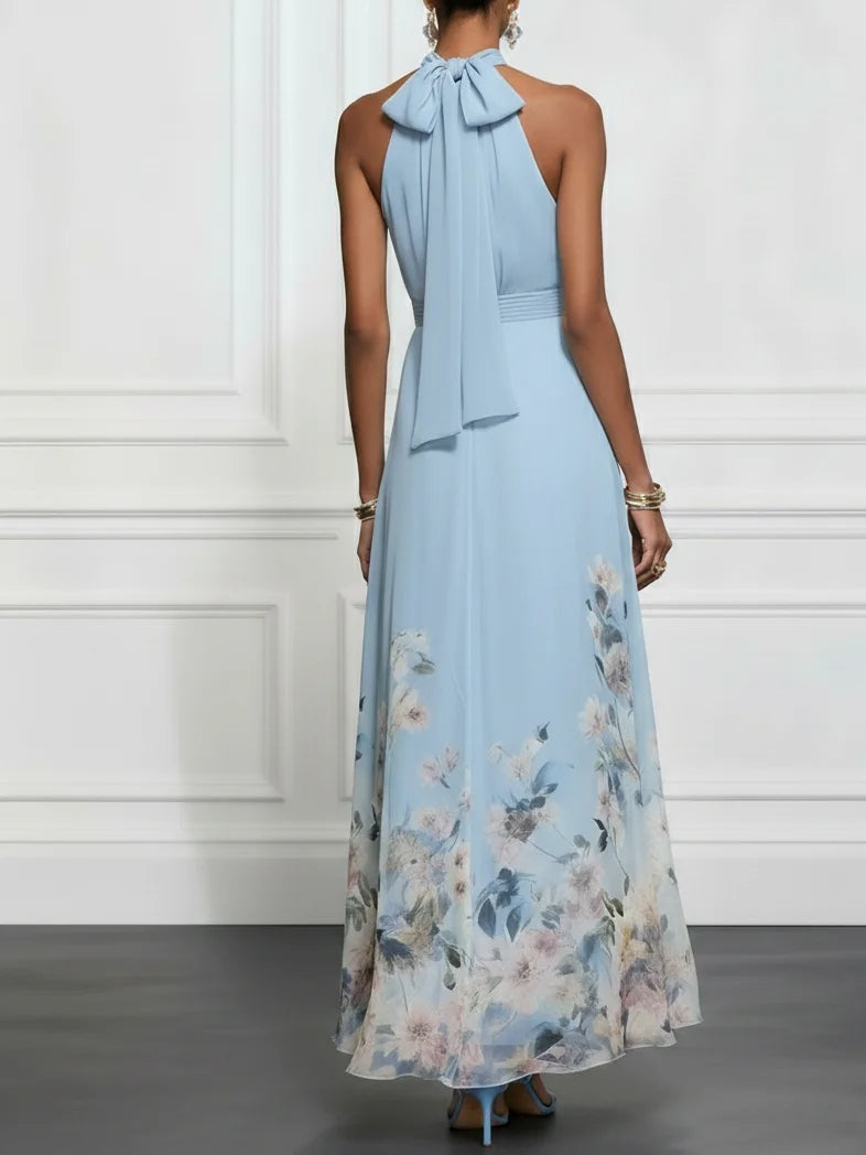 Back view of light blue halter maxi dress with neck tie and floral hem
