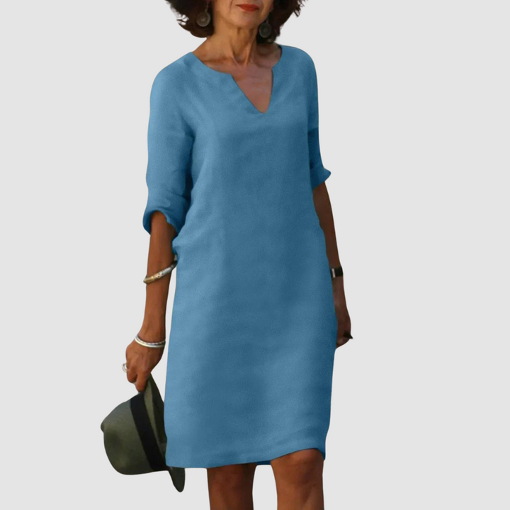 Light blue V-neck shift dress with 3/4 sleeves, knee length.