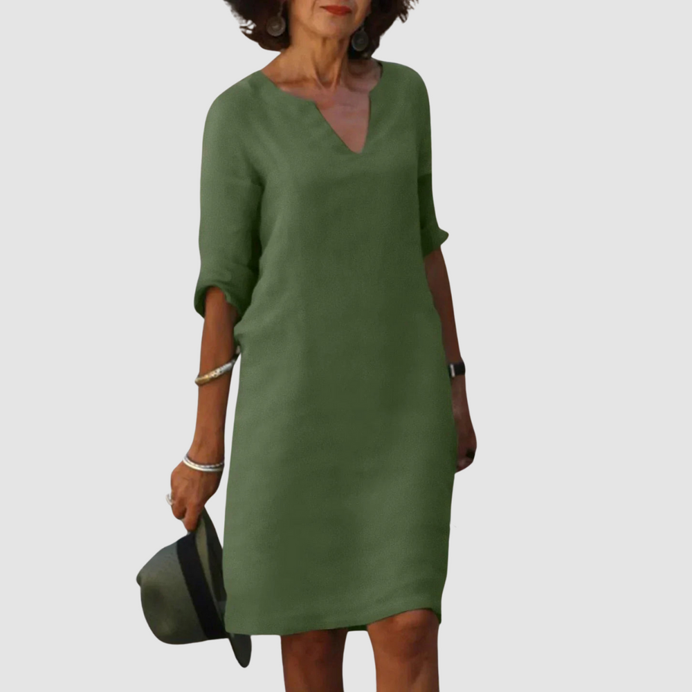 Dark green V-neck shift dress with 3/4 sleeves, knee length.
