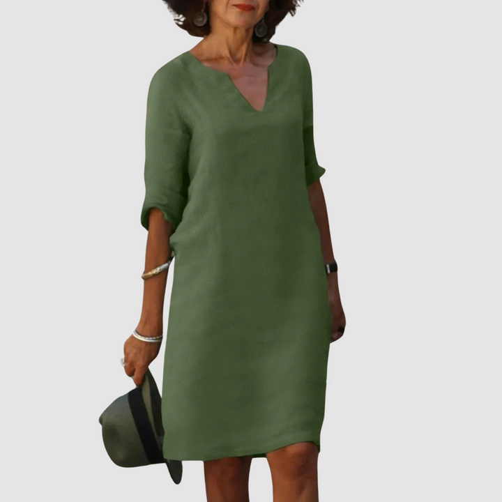 Dark green V-neck shift dress with 3/4 sleeves, knee length.