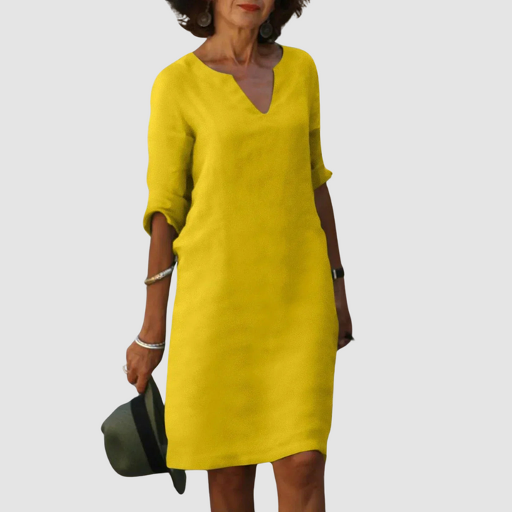 Yellow V-neck shift dress with 3/4 sleeves, knee length.