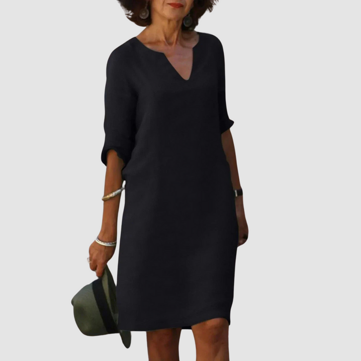Black V-neck shift dress with 3/4 sleeves, knee length.