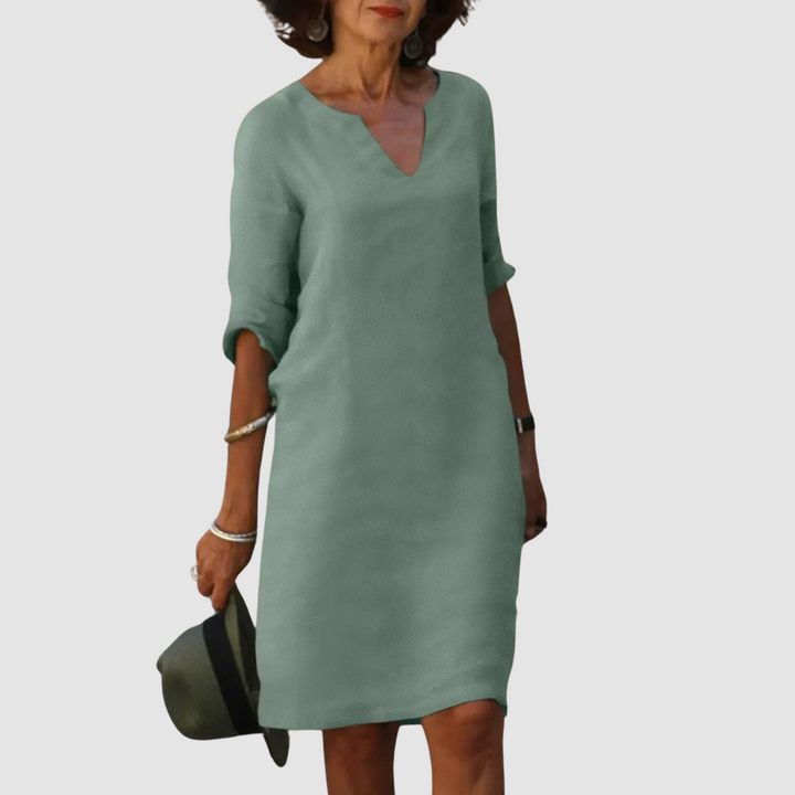 Light green V-neck shift dress with 3/4 sleeves, knee length.