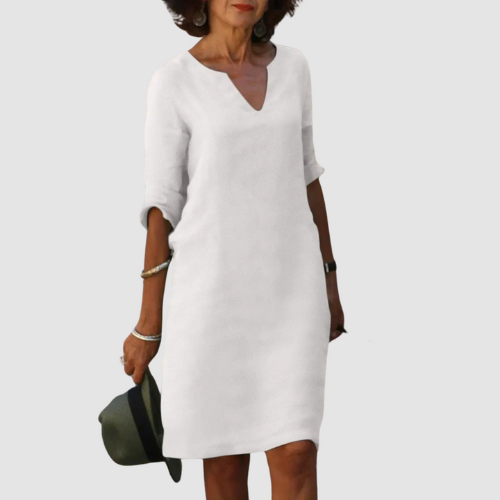 White V-neck shift dress with 3/4 sleeves, knee length.