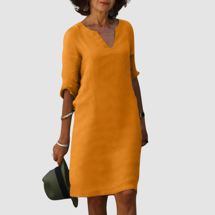 Orange V-neck shift dress with 3/4 sleeves, knee length.