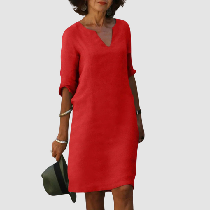 Red V-neck shift dress with 3/4 sleeves, knee length.