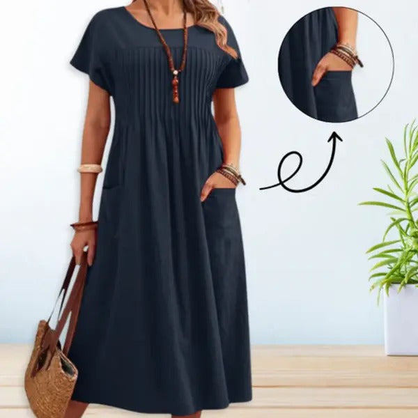 Blue midi day dress, round neck, short sleeves, gathered front, patch pockets.