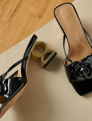 Black statement heels with rose applique, open toe, thin straps, chunky heel