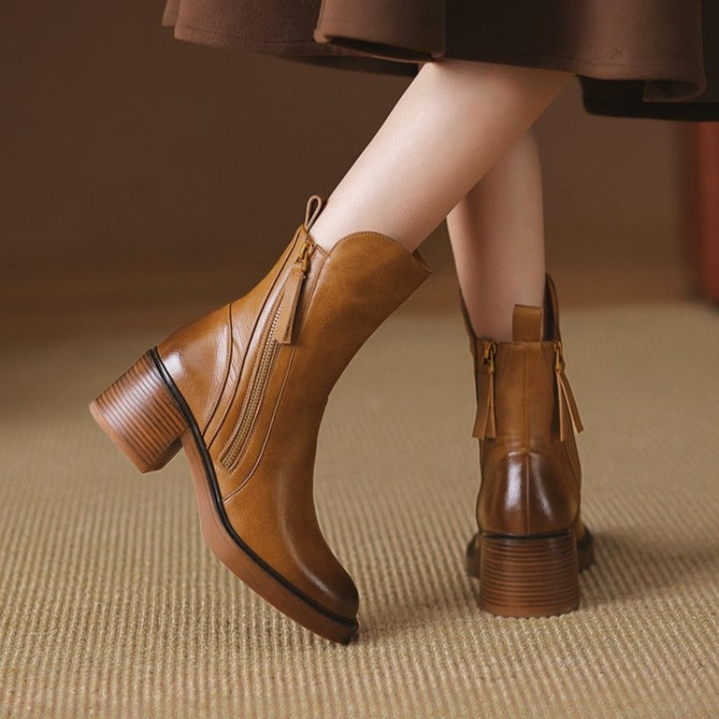 Brown ankle boots with side zipper, tassel pull, and stacked block heel