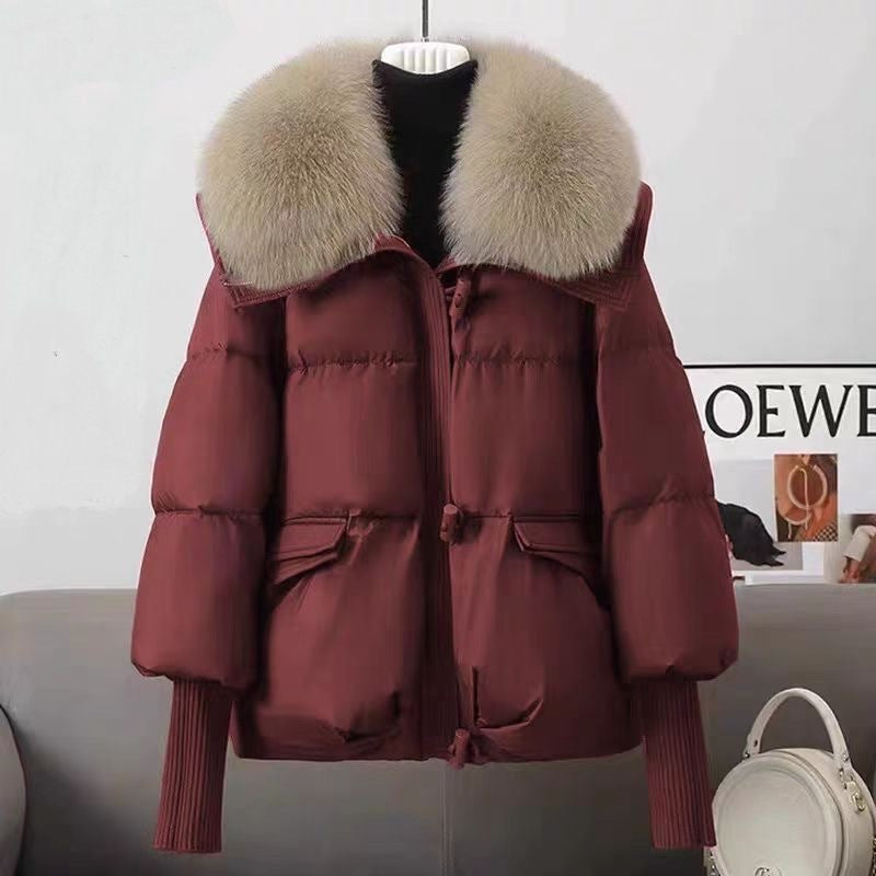 Red puffer jacket with faux fur collar, front zipper, flap pockets, ribbed knit cuffs