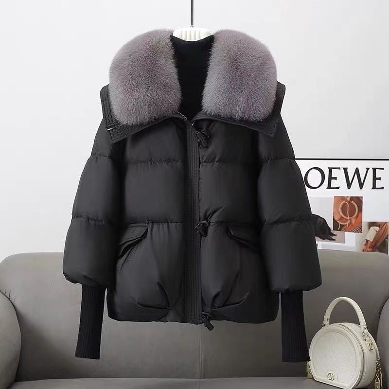 Black puffer jacket with faux fur collar, front zipper, flap pockets, ribbed knit cuffs