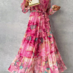 Floral tiered maxi dress with pink V-neck and long ruffle sleeves, belted waist