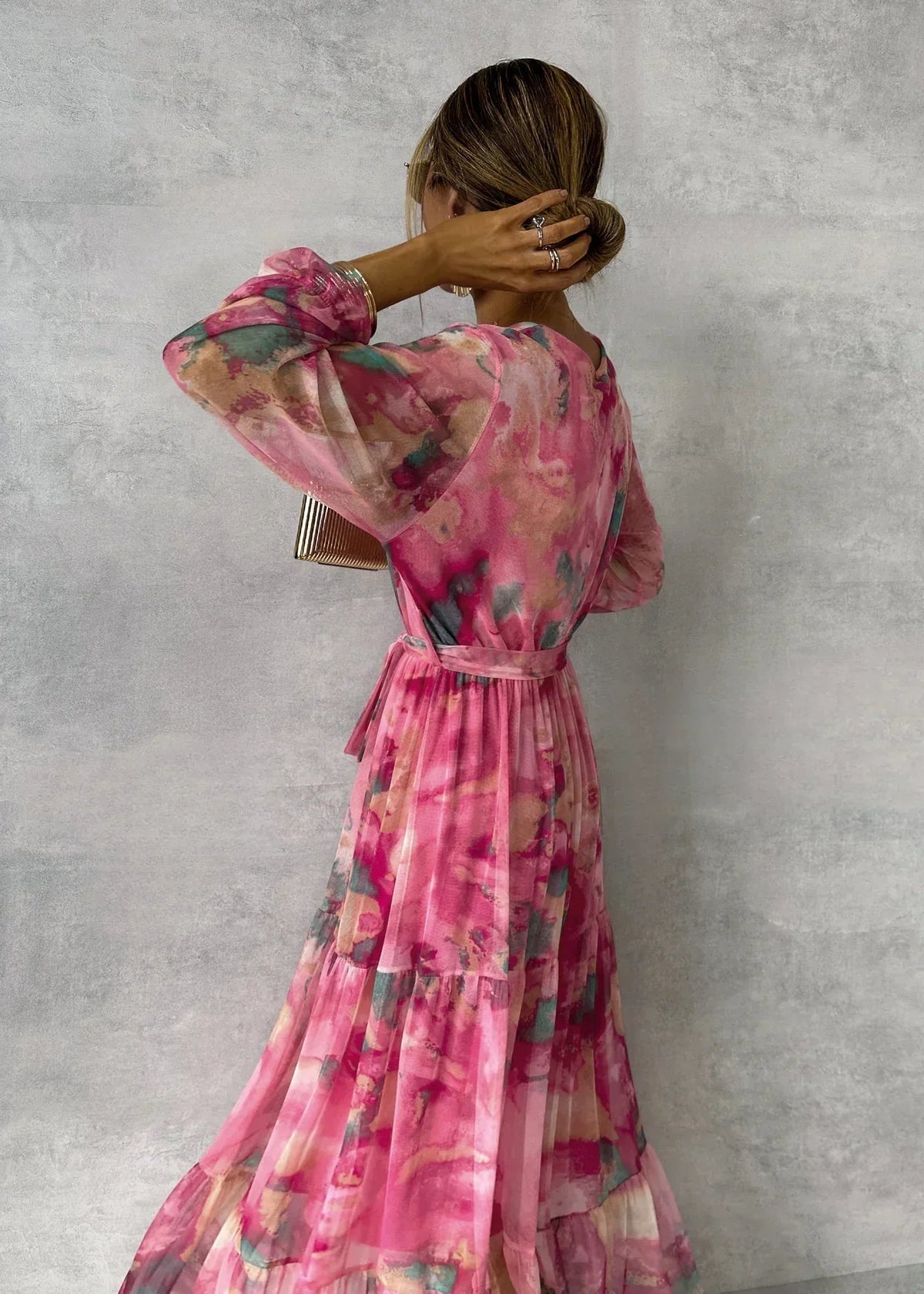 Floral tiered maxi dress in pink with belted waist and long sheer sleeves, back view