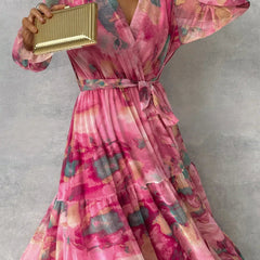 Floral tiered maxi dress with pink V-neck, belted waist, and colorful long ruffle sleeves