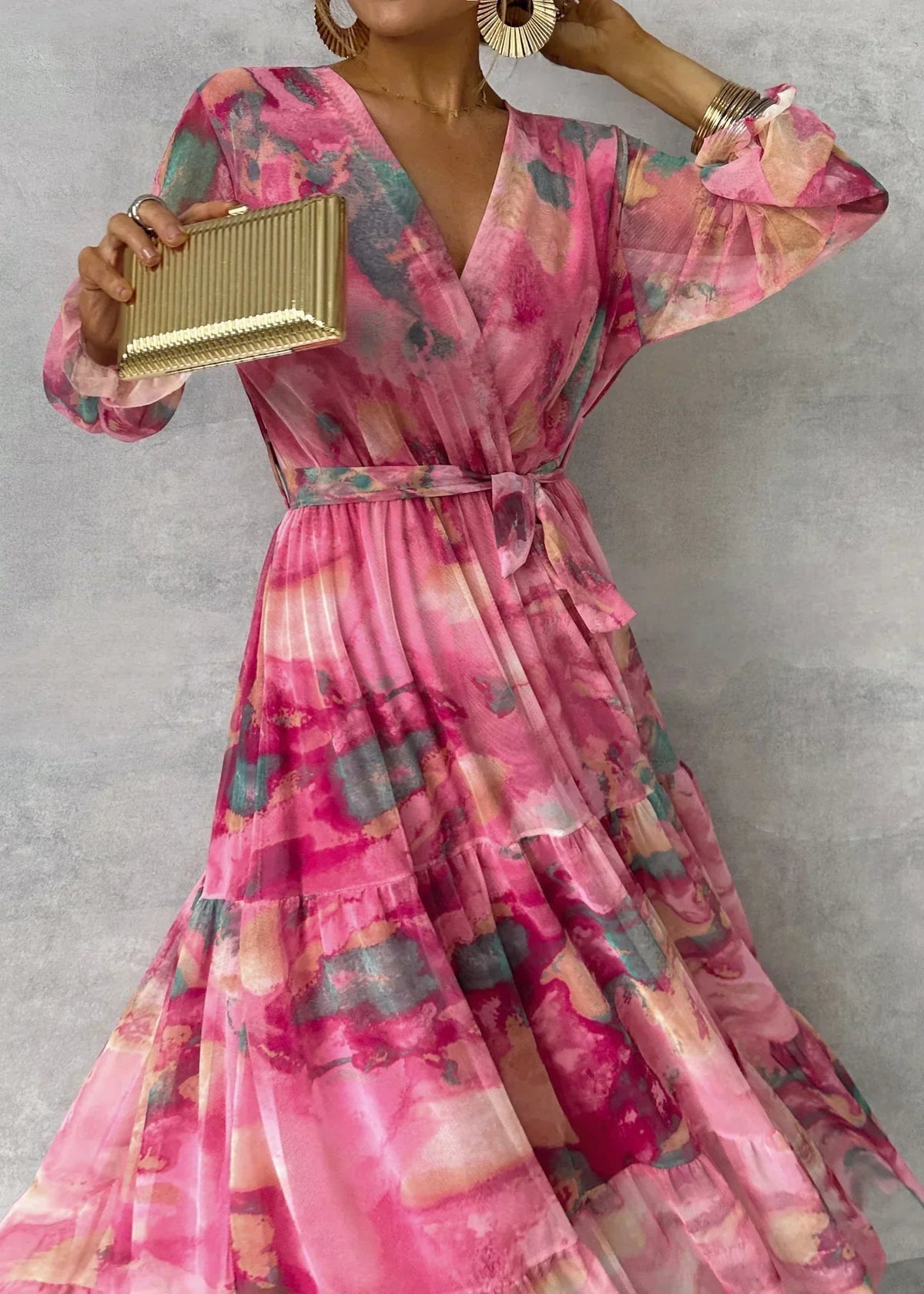 Floral tiered maxi dress with pink V-neck, belted waist, and colorful long ruffle sleeves