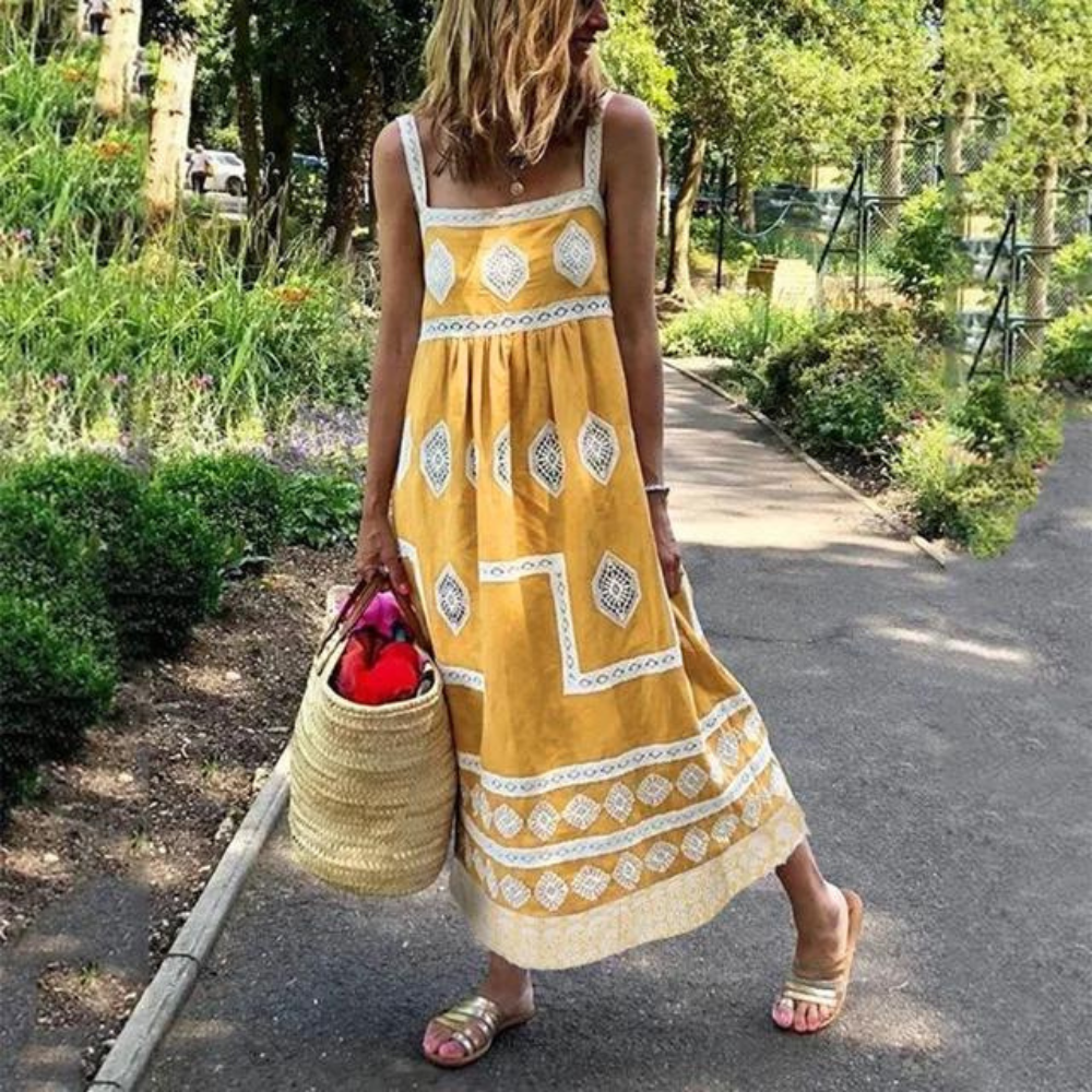 Sleeveless vintage dress in yellow with white diamond medallion print and tiered hem