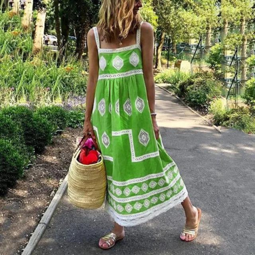 Sleeveless vintage dress in green with white diamond medallion print and tiered hem