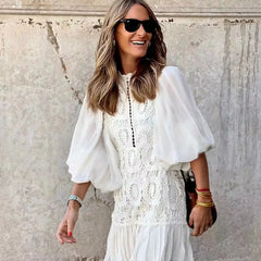 White embroidered lace mini dress with sheer puff sleeves and tiered ruffle skirt