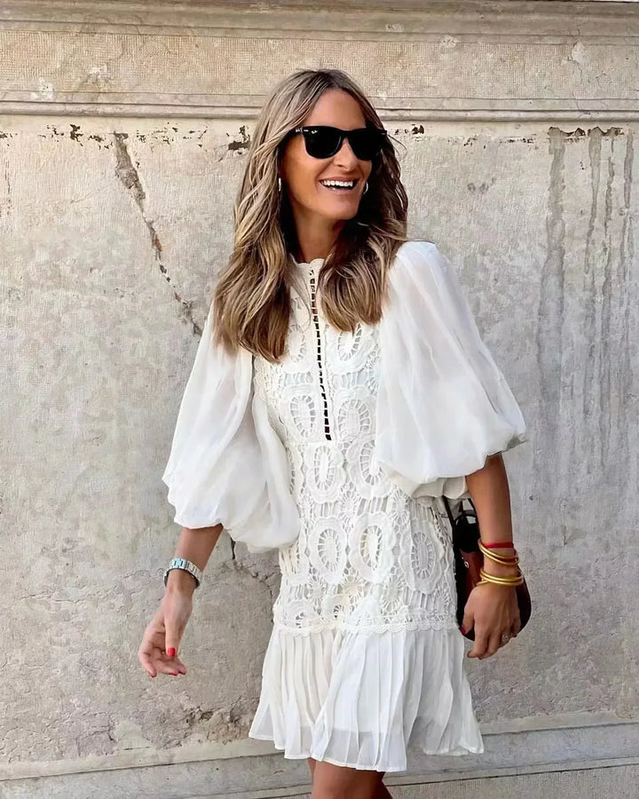 White embroidered lace mini dress with sheer puff sleeves and tiered ruffle skirt