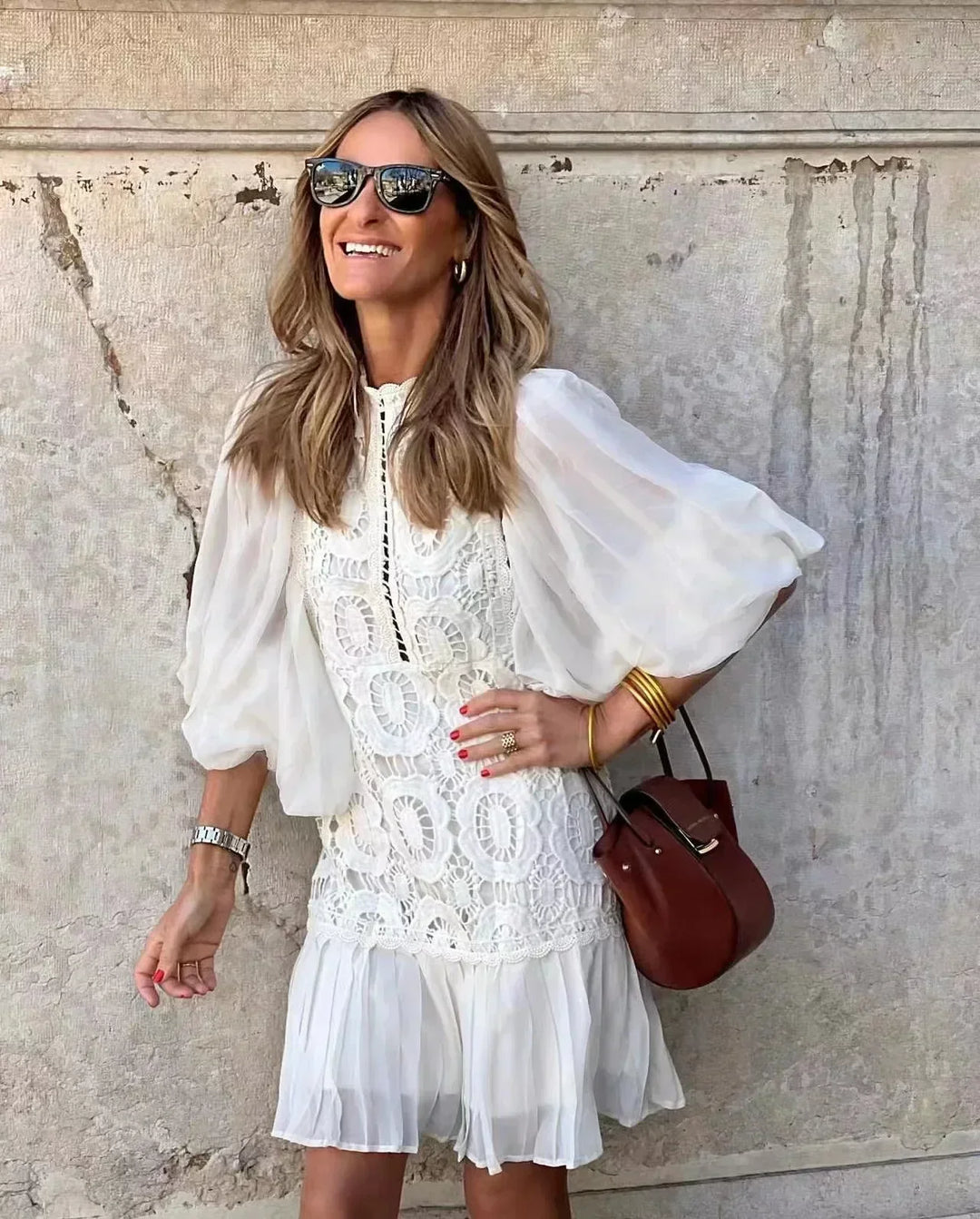 White embroidered lace mini dress with high collar, sheer sleeves, tiered skirt