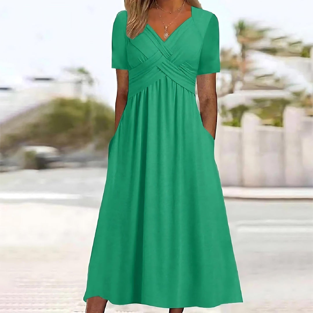 Green midi dress with V-neck, short sleeves, and ruched crossover waist