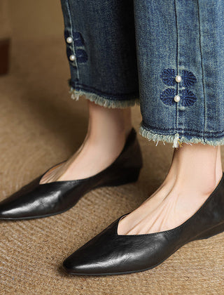 Black genuine leather mules on feet, almond toe slip-on design